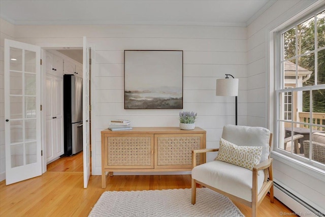 15 Thompson Hill Rd, Canton, CT 06019 - living area featuring a baseboard heating unit, ornamental molding, and light wood-type flooring