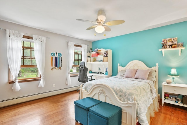 58 Inca Dr, Trumbull, CT 06611 - bedroom with multiple windows, a baseboard heating unit, wood finished floors, and a ceiling fan