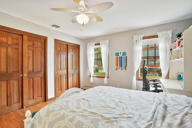 58 Inca Dr, Trumbull, CT 06611 - bedroom featuring multiple closets, baseboard heating, light wood-style flooring, and ceiling fan