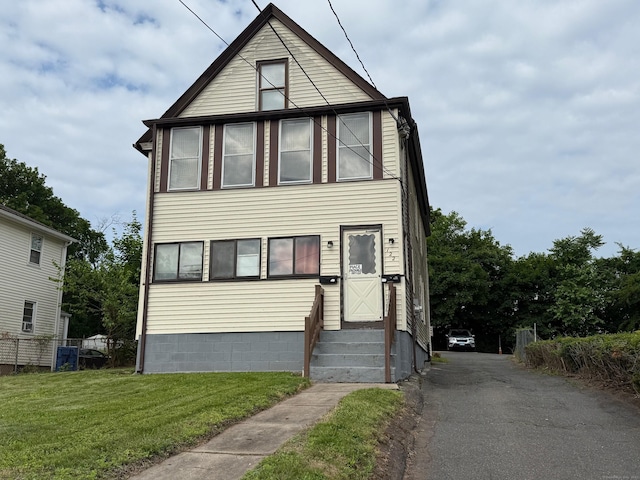 122 Wilcox St, New Britain, CT 06051 - view of front facade featuring entry steps, a front yard, and driveway