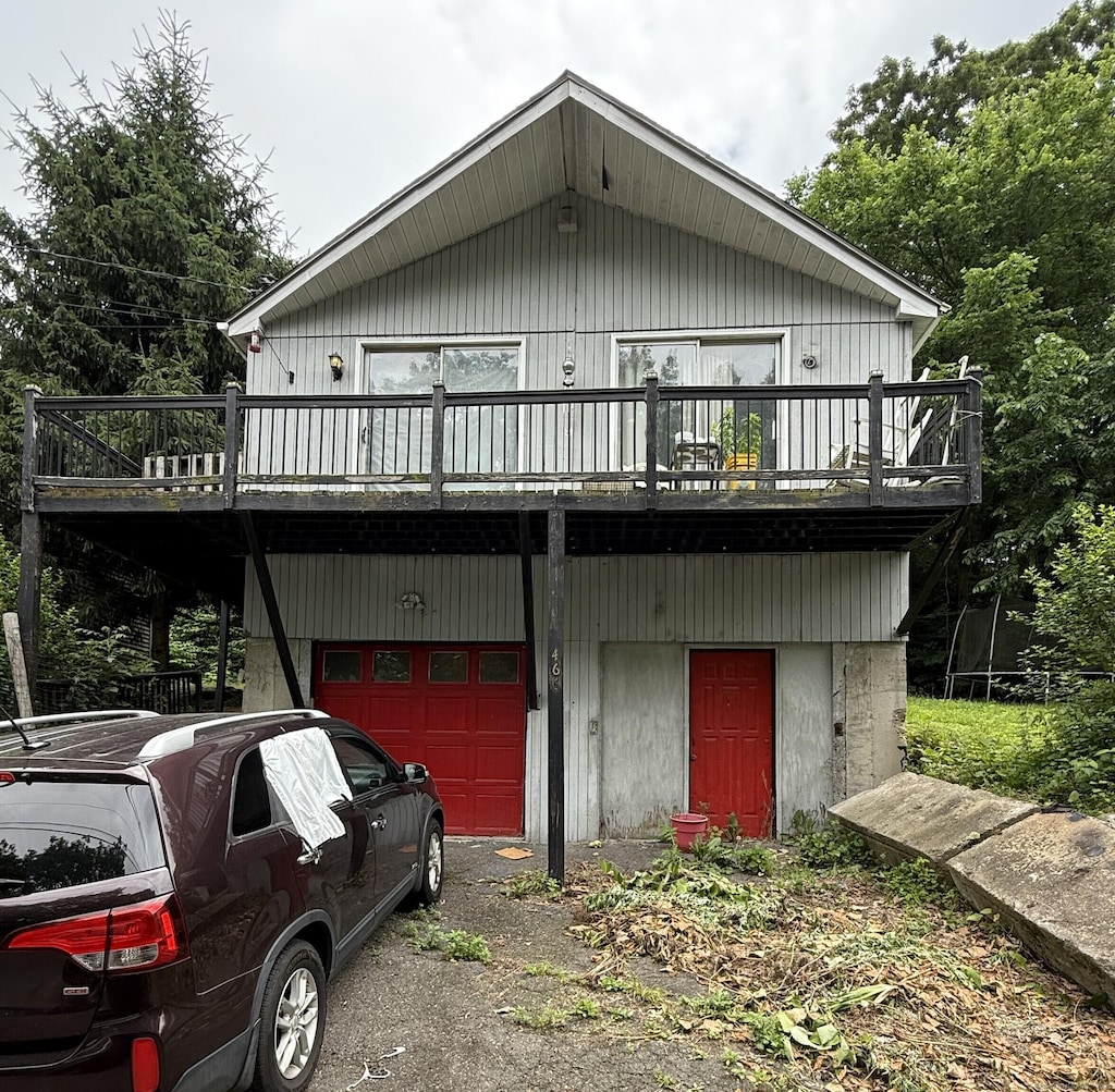 466 Waterville St, Waterbury, CT 06710 - view of front of house featuring a garage, a deck, and asphalt driveway