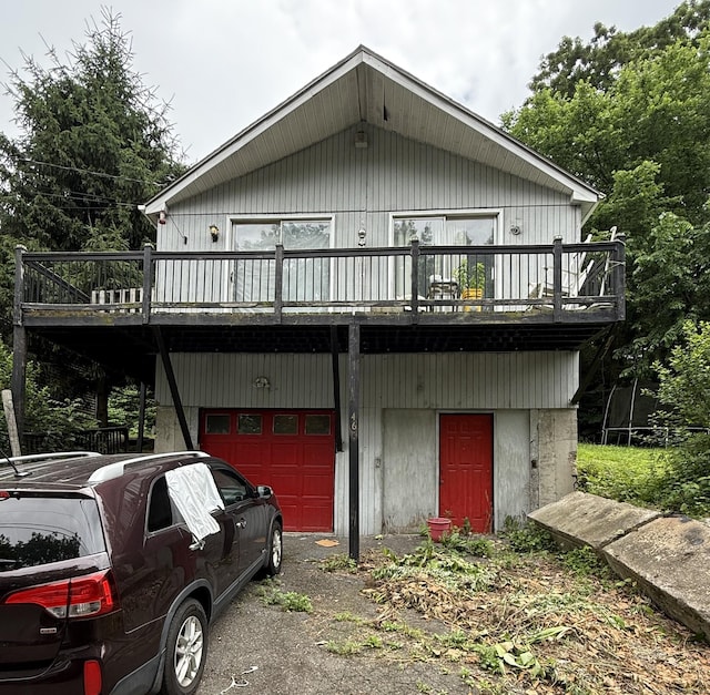 466 Waterville St, Waterbury, CT 06710 - view of front of house featuring a garage, a deck, and asphalt driveway