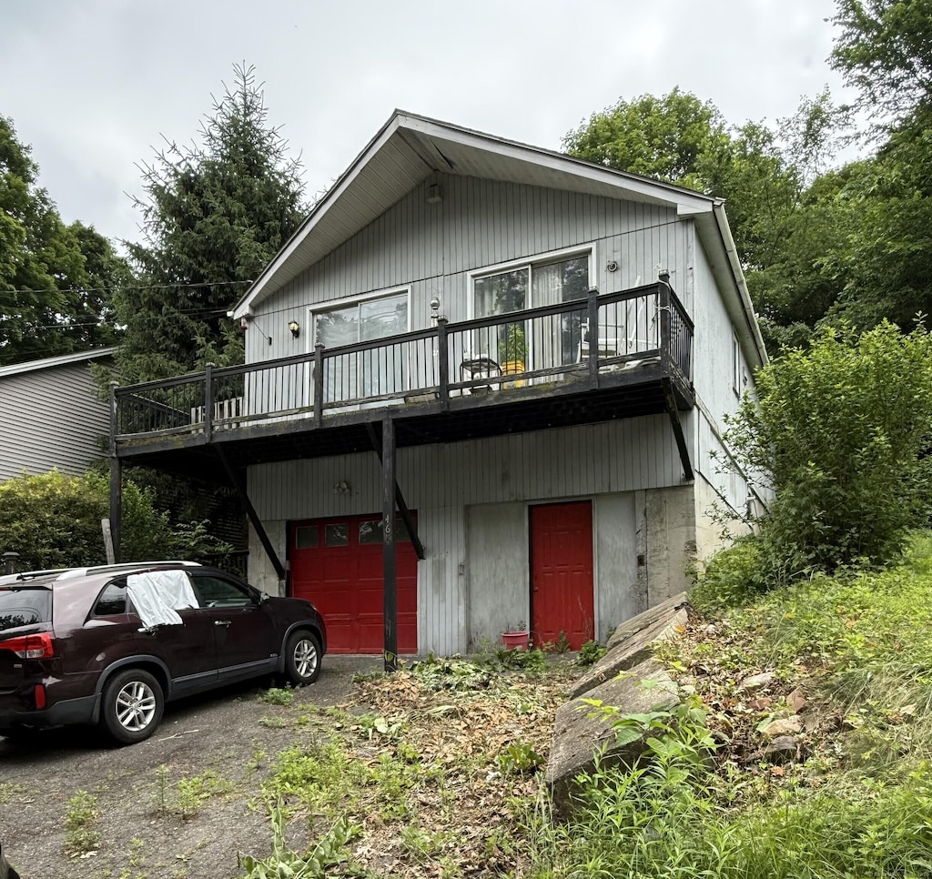 466 Waterville St, Waterbury, CT 06710 - view of front of home featuring a wooden deck, asphalt driveway, and an attached garage