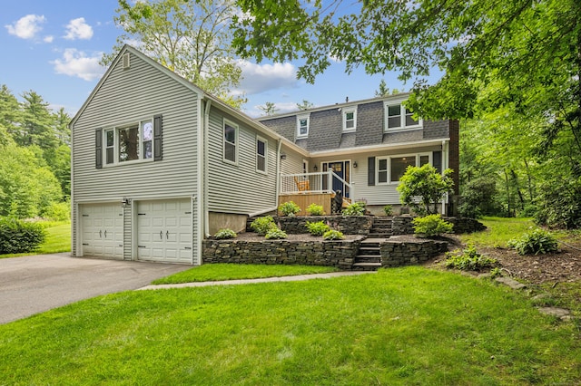 28 Saddle Ridge Dr, Simsbury, CT 06092 - view of front of property with an attached garage, asphalt driveway, and a front yard
