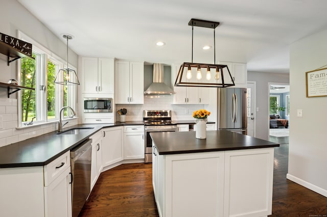 28 Saddle Ridge Dr, Simsbury, CT 06092 - kitchen with appliances with stainless steel finishes, wall chimney range hood, dark countertops, tasteful backsplash, and recessed lighting
