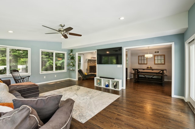 28 Saddle Ridge Dr, Simsbury, CT 06092 - living area with dark wood-style flooring, healthy amount of natural light, a stone fireplace, a ceiling fan, and recessed lighting