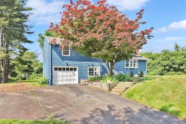 39 Alder Rd, Simsbury, CT 06070 - obstructed view of property with a front yard, an attached garage, and driveway