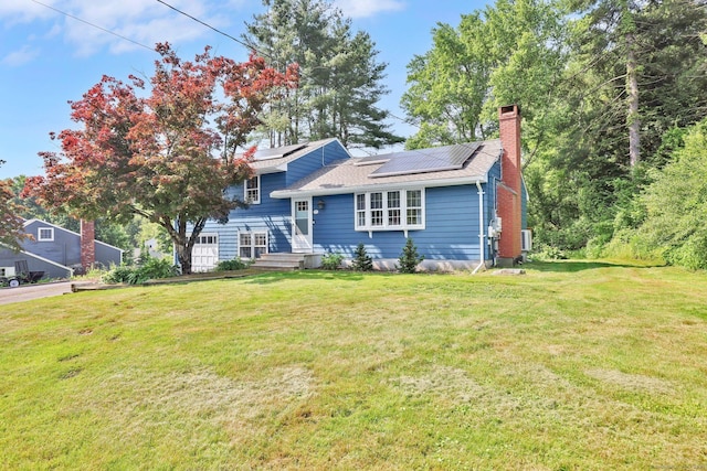 39 Alder Rd, Simsbury, CT 06070 - split level home featuring solar panels, a front yard, and a chimney