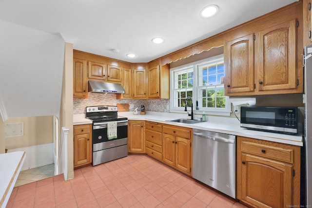 39 Alder Rd, Simsbury, CT 06070 - kitchen featuring stainless steel appliances, under cabinet range hood, light countertops, decorative backsplash, and light tile patterned floors