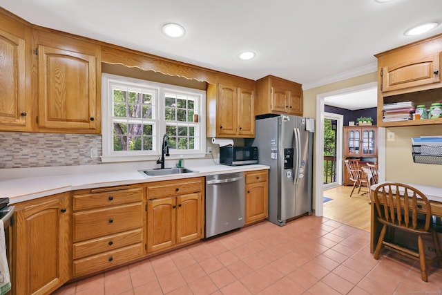 39 Alder Rd, Simsbury, CT 06070 - kitchen featuring stainless steel appliances, light countertops, light tile patterned flooring, tasteful backsplash, and ornamental molding