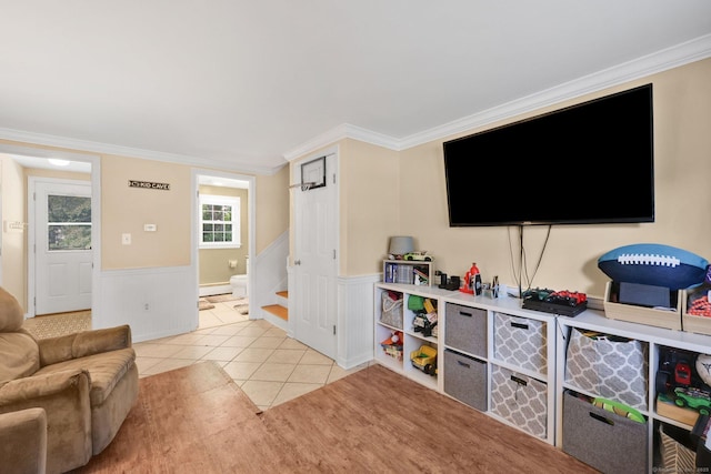 39 Alder Rd, Simsbury, CT 06070 - living area with a wainscoted wall, stairs, light tile patterned flooring, crown molding, and a baseboard radiator