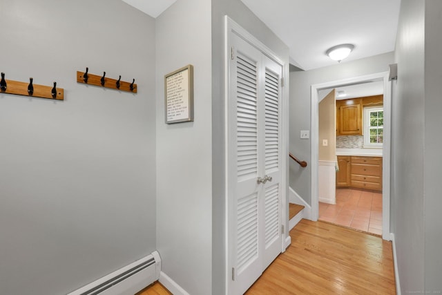 39 Alder Rd, Simsbury, CT 06070 - corridor featuring baseboard heating, light wood-type flooring, and an upstairs landing