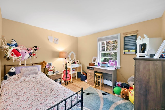 39 Alder Rd, Simsbury, CT 06070 - bedroom with wood finished floors and a baseboard radiator