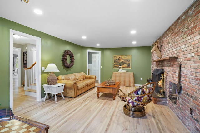 17 Mail Coach Dr, Norwalk, CT 06850 - living room with wood finished floors, brick wall, stairway, and recessed lighting