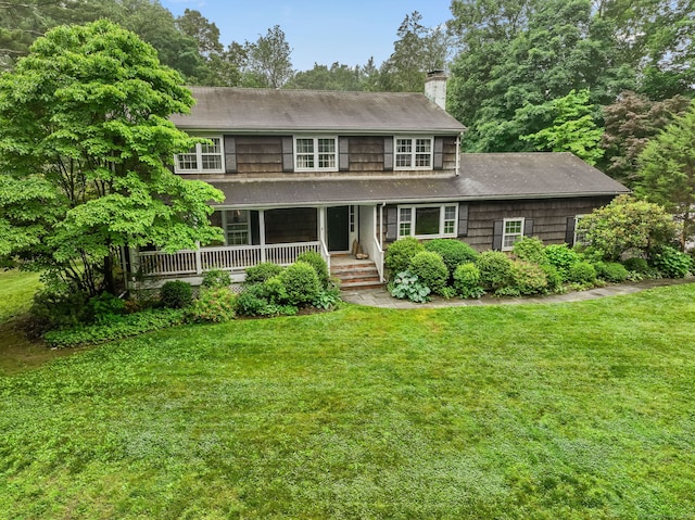 17 Mail Coach Dr, Norwalk, CT 06850 - view of front of home with a chimney, a front yard, covered porch, and roof with shingles