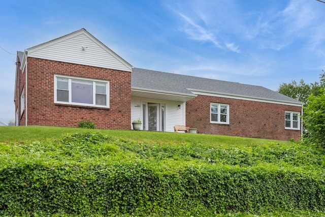 171 Ashton St, Bridgeport, CT 06606 - view of front of property featuring brick siding, a front yard, and a shingled roof