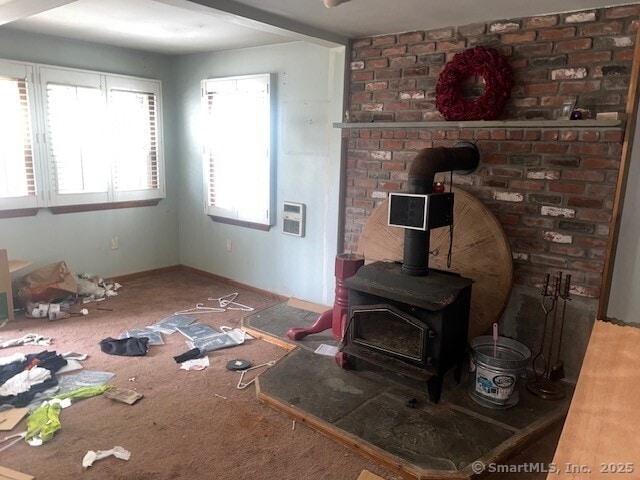 51 N Cliff St, Norwich, CT 06360 - living room with a wood stove, carpet, and heating unit