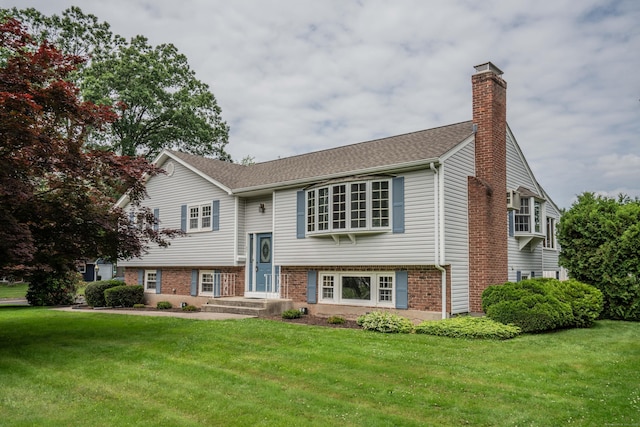 62 Eddy Ln, Newington, CT 06111 - split foyer home featuring a chimney, a front yard, and brick siding