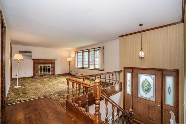62 Eddy Ln, Newington, CT 06111 - foyer entrance featuring a wall mounted air conditioner, wood finished floors, a brick fireplace, and a baseboard heating unit