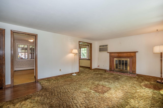 62 Eddy Ln, Newington, CT 06111 - unfurnished living room featuring a baseboard heating unit, carpet flooring, a brick fireplace, and an AC wall unit