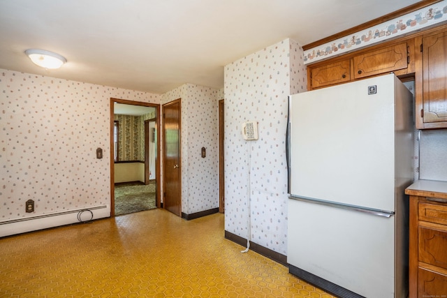 62 Eddy Ln, Newington, CT 06111 - kitchen featuring freestanding refrigerator, wallpapered walls, a baseboard heating unit, brown cabinetry, and light floors