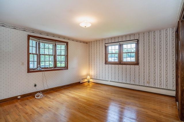 62 Eddy Ln, Newington, CT 06111 - empty room featuring a baseboard heating unit, wood finished floors, and wallpapered walls