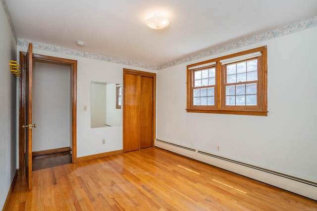 62 Eddy Ln, Newington, CT 06111 - unfurnished bedroom with baseboard heating, light wood-style flooring, and a closet