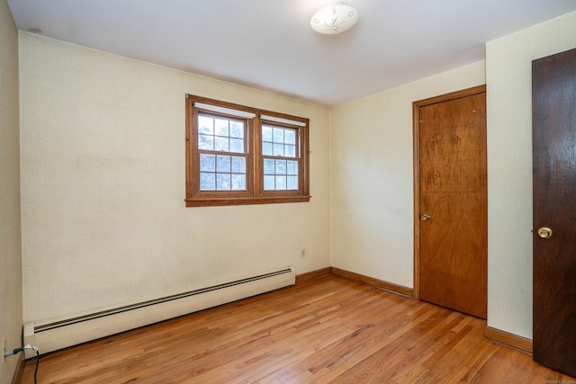 62 Eddy Ln, Newington, CT 06111 - unfurnished room featuring a baseboard heating unit and light wood-style floors