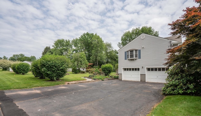 62 Eddy Ln, Newington, CT 06111 - view of property exterior with asphalt driveway, an attached garage, and a lawn
