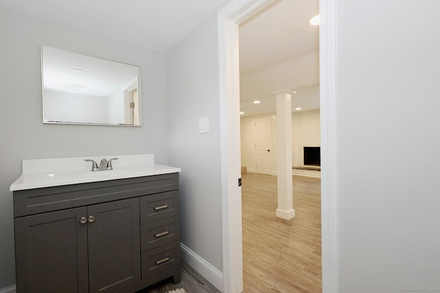 3743 Park Ave, Fairfield, CT 06825 - bathroom featuring wood finished floors, vanity, decorative columns, and recessed lighting