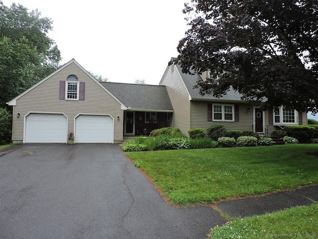 14 Cartier Rd, Enfield, CT 06082 - view of front facade featuring driveway, a front lawn, roof with shingles, and a garage