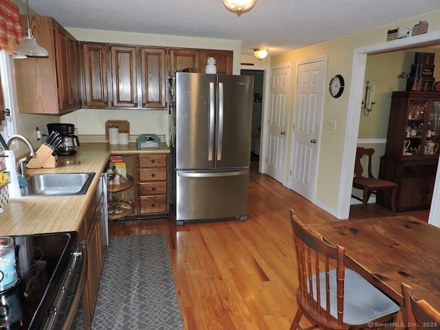 14 Cartier Rd, Enfield, CT 06082 - kitchen with stainless steel appliances, light wood finished floors, butcher block countertops, and pendant lighting