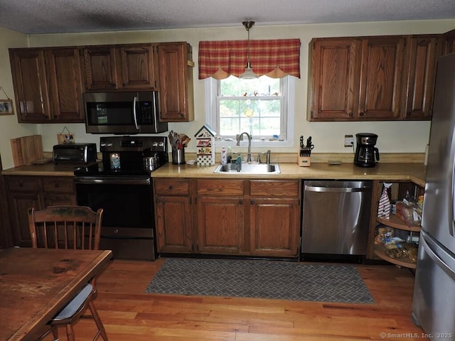 14 Cartier Rd, Enfield, CT 06082 - kitchen with appliances with stainless steel finishes, light countertops, and light wood finished floors