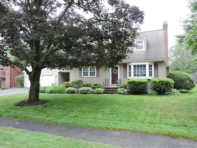 14 Cartier Rd, Enfield, CT 06082 - view of front of home with a chimney, a front lawn, driveway, and an attached garage