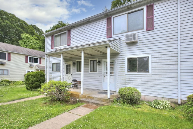 121 Lexington Ave Unit 21, New Haven, CT 06513 - view of front of property featuring covered porch, a front lawn, and an AC wall unit