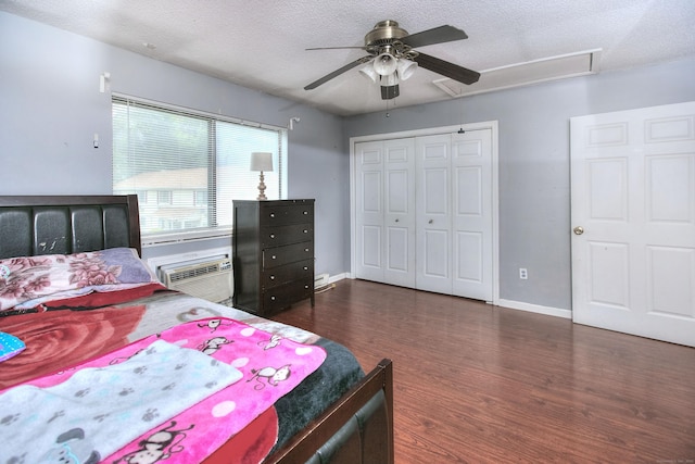 121 Lexington Ave Unit 21, New Haven, CT 06513 - bedroom featuring dark wood-type flooring, a closet, a wall unit AC, a textured ceiling, and a ceiling fan