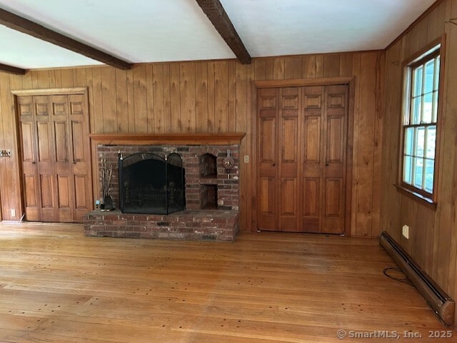 147 Beers Rd, Easton, CT 06612 - unfurnished living room featuring baseboard heating, beamed ceiling, wooden walls, a fireplace, and hardwood / wood-style floors