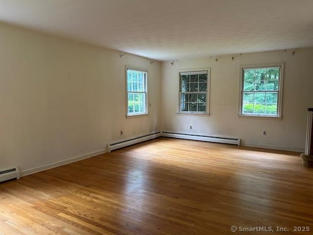147 Beers Rd, Easton, CT 06612 - unfurnished room with wood finished floors, healthy amount of natural light, and baseboard heating