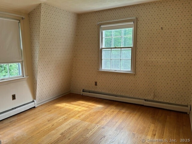 147 Beers Rd, Easton, CT 06612 - empty room with a baseboard radiator, wallpapered walls, and light wood-style floors