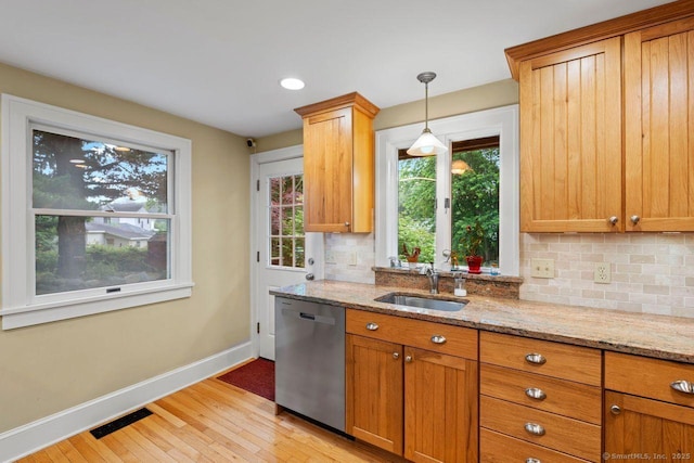 160 Disbrow St, Stratford, CT 06614 - kitchen featuring dishwasher, tasteful backsplash, light stone counters, light wood-style flooring, and brown cabinetry