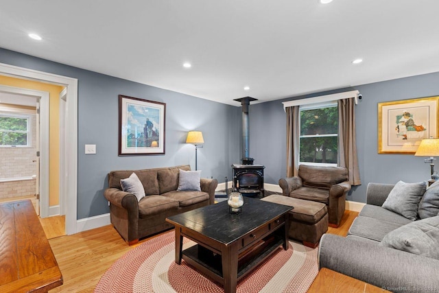 160 Disbrow St, Stratford, CT 06614 - living area with a wood stove, light wood-style flooring, and recessed lighting