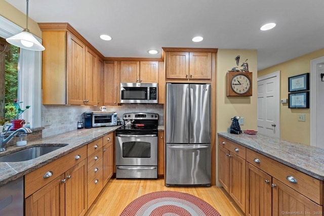 160 Disbrow St, Stratford, CT 06614 - kitchen featuring appliances with stainless steel finishes, brown cabinets, and recessed lighting