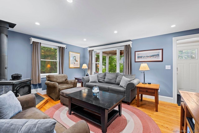 160 Disbrow St, Stratford, CT 06614 - living room featuring a wood stove, plenty of natural light, recessed lighting, and light wood finished floors