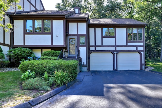 690 Forest Rd Unit 394, West Haven, CT 06516 - tudor home with stucco siding, a garage, driveway, and a shingled roof