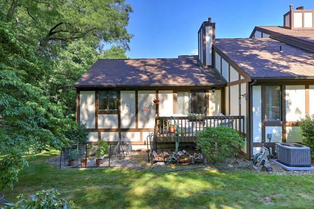 690 Forest Rd Unit 394, West Haven, CT 06516 - back of house featuring a shingled roof, a chimney, a yard, and a deck