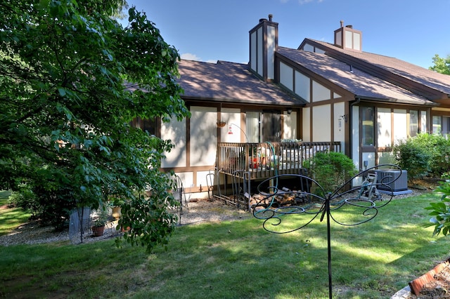 690 Forest Rd Unit 394, West Haven, CT 06516 - back of house with a chimney, roof with shingles, and a yard