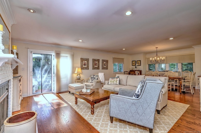 690 Forest Rd Unit 394, West Haven, CT 06516 - living room featuring a brick fireplace, a chandelier, healthy amount of natural light, crown molding, and recessed lighting