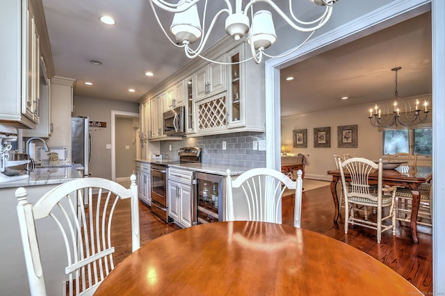 690 Forest Rd Unit 394, West Haven, CT 06516 - dining room featuring beverage cooler, a chandelier, dark wood-type flooring, recessed lighting, and crown molding