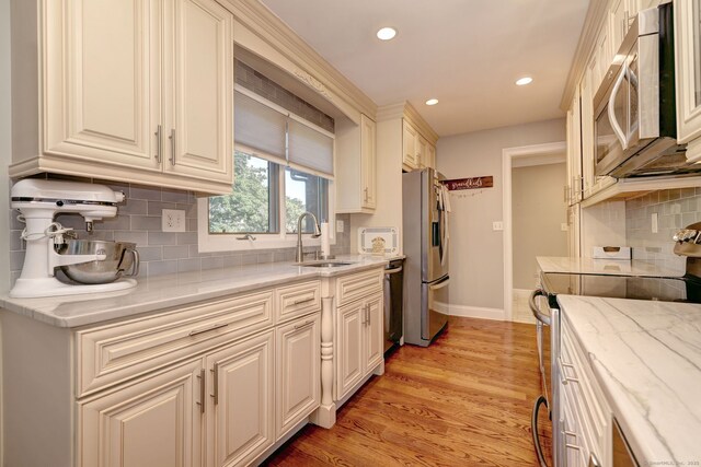 690 Forest Rd Unit 394, West Haven, CT 06516 - kitchen featuring stainless steel appliances, recessed lighting, backsplash, light stone counters, and light wood-style floors