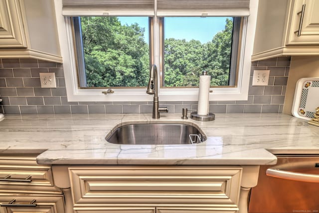 690 Forest Rd Unit 394, West Haven, CT 06516 - kitchen with decorative backsplash, light stone counters, dishwasher, and cream cabinetry